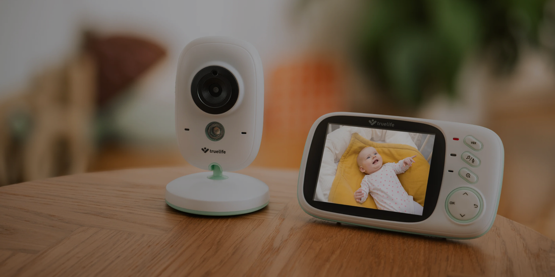 Baby monitor with camera and display on a wooden surface

