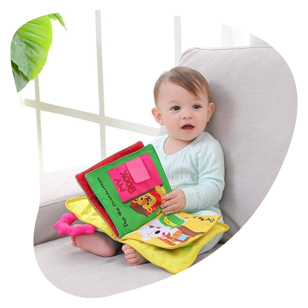 Baby Holding Colorful Book on Sofa
